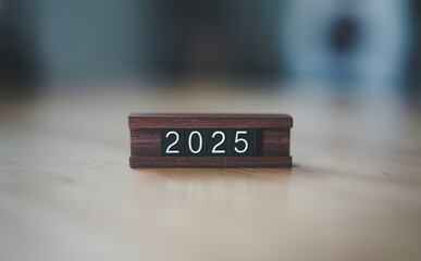 Starting new year 2025. Flipping of 2024 to 2025 on wooden cube blocks. Beginning and start of the...