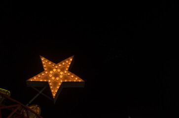 A large illuminated star against a dark background