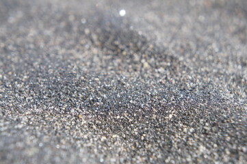 black and white sand on the beach