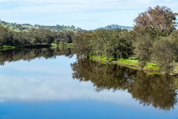 Smooth calm river section with reflections