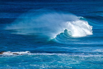 Waves curling, breaking, and frothing