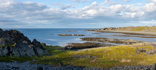 Untamed and rugged coast of Barents Sea on a warm summer evening. Hamningber, Varanger Peninsula