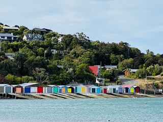 Colourful boat sheds along  the beach
