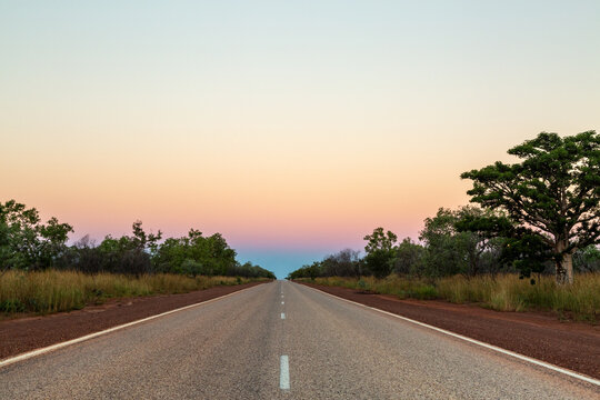 Bitumen road and pastel sunset in Western Australia