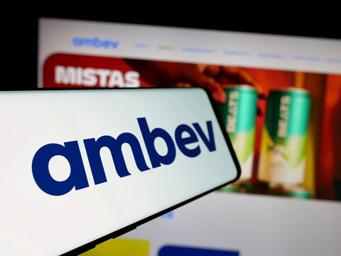 Stuttgart, Germany - 12-04-2024: Mobile phone with logo of Brazilian beverage company Ambev SA on screen in front of business website. Focus on center-left of phone display.