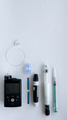 Diabetes management devices, insulin pump, glucometer, injection, and syringe on white background