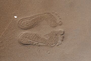 Close up of footprints on sand beach texture background