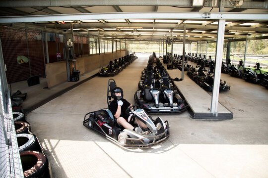 Teenager sitting in go-kart ready to race