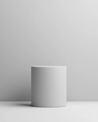 Fototapeta premium Minimalist cylindrical platform against a soft gray background for product display.