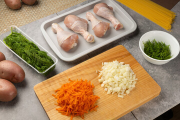Ingredients - vegetables and meat for  cooking chicken soup in kitchen with meal prep on wood board. Healthy nutrition and diet..Preparing for cooking...