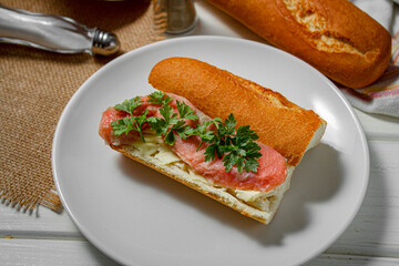 Sandwich with smoked red fish on a light table