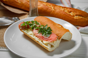 Sandwich with smoked red fish on a light table