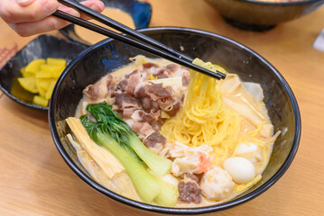 Authentic Korean Malatang Hotpot with Fresh Ingredients and Noodles in a Casual Restaurant Setting