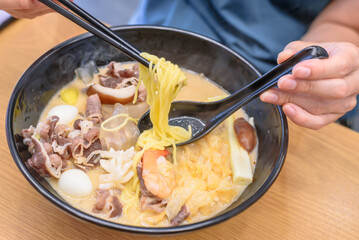Authentic Korean Malatang Hotpot with Fresh Ingredients and Noodles in a Casual Restaurant Setting