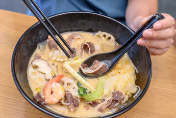 Authentic Korean Malatang Hotpot with Fresh Ingredients and Noodles in a Casual Restaurant Setting