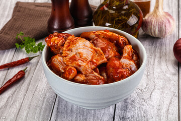 Raw marinated buffalo chicken wings