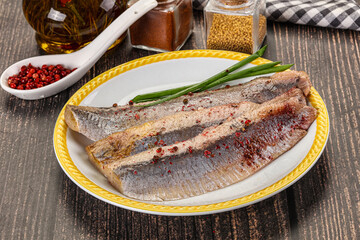 Salted marinated herring fillet with spices