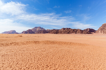 Scenic view of Wadi Rum Desert in Jordan. Landscape with Rocky Formation Under Blue Sky and Wispy Clouds..