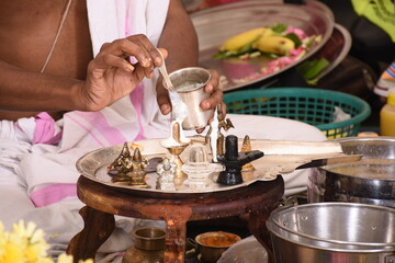 Performing Pooja for Hindu god siva linga with milk, honey and coconut water	
