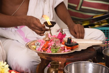 Performing Pooja for Hindu god siva linga with milk, honey and coconut water	
