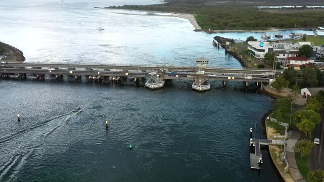 Aerial landing over Swansea channel in Swansea town of Australia-stormy clouds.
