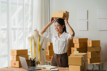 Happy Business Owner with Boxes on her Head 