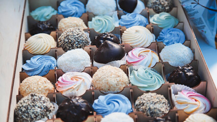 Tempting display of sweetness, marshmallows and chocolate cakes arranged in a wooden box