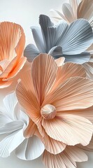Gigantic pleated flowers made of paper, in a peach and grey color palette, against a white background