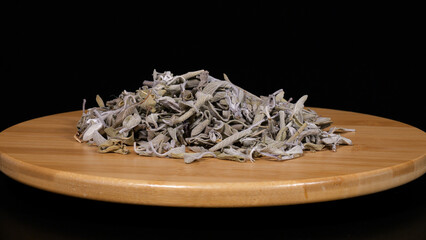 Close-up image of dried sage on black background.