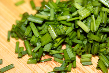 Chopped Up Sliced Chive Herb on a Chopping Board in Kitchen