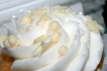 Close Up of Cupcake Cake Icing and Frosting in Chocolate with ball Decoration