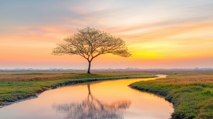 The vibrant hues of orange, pink, and purple fill the sky as the sun dips below the horizon, casting a warm glow over the tranquil landscape