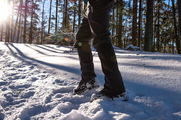Man's legs close-up. Boot And Gaiters Of Mountaineer On The Snowy Path.