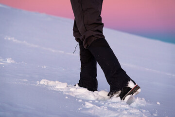 Man's legs close-up. Boot And Gaiters Of Mountaineer On The Snowy Path.