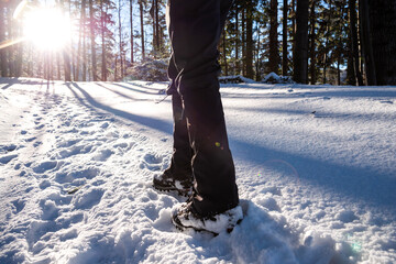 Man's legs close-up. Boot And Gaiters Of Mountaineer On The Snowy Path.