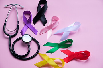 colorful ribbons on pink background, cancer awareness, World cancer day, National cancer survivor day,
