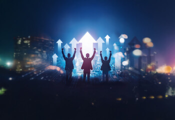 Three silhouettes of people stand with arms raised in victory against a cityscape backdrop. White glowing arrows point upward representing growth and success.