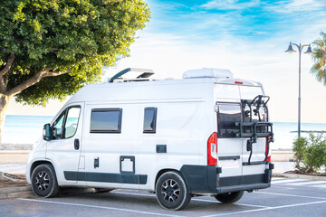 modern white camper van L2 H2 with bike carrier cooler, skylights, folding windows, parked next to...