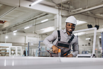 Factory worker assembling aluminum and pvc windows and doors