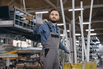 Fototapeta premium Factory worker making stop gesture in aluminum and pvc windows and doors production