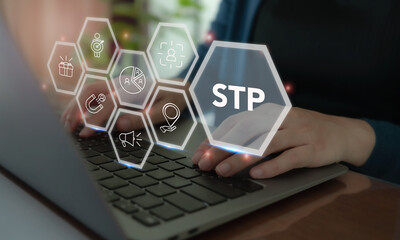 Fototapeta premium Segmentaion, targeting, positioning STP Marketing Model. Working on laptop with STP icon. Identify different customer groups, select groups to prioritize, and create brand’s unique value proposition.
