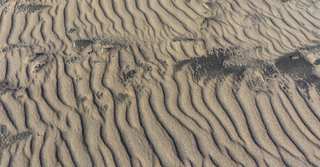 Sand patterns and ripples caused by sea on beach