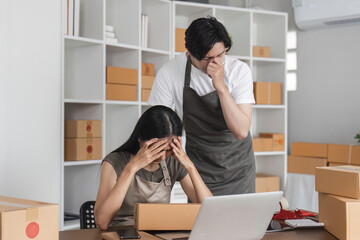 Stressed Couple Analyzing Stock Market Data Online at Home Office with Laptop and Boxes