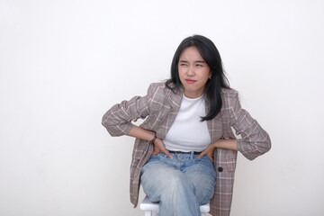 Painful facial expression of a young Indonesian woman suffering from bad stomachache
