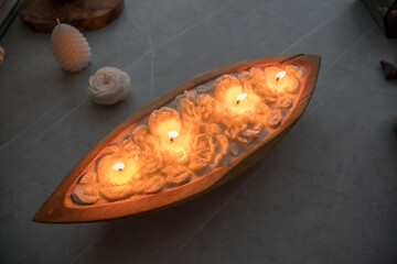 Beautiful candle with flowers in a wooden candlestick