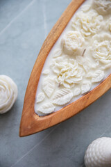 Beautiful candle with flowers in a wooden candlestick