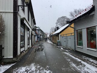 Snowfall in April in old street in the city of Sigtuna