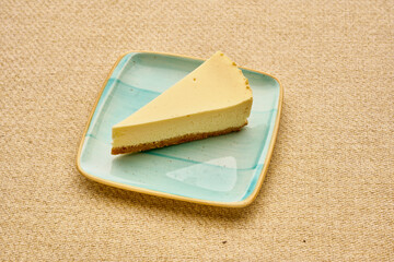 A slice of cheesecake is on a blue plate