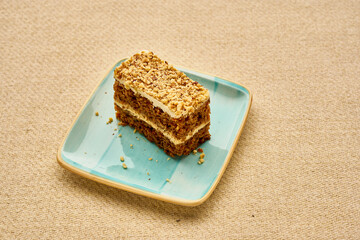 A slice of carrot cake sits on a blue plate