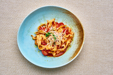 A plate of pasta with cheese and tomato sauce